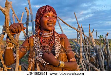 Turmi Ethiopia Africa Lower Omo Valley village with Bena Tribe First Wife smiling in sunset in wood hut village 24 View Large Photo Image Stock Image - Turmi Ethiopia Africa Lower Omo Valley village with Bena Tribe First Wife smiling in sunset in wood hut village 24. Fotosearch