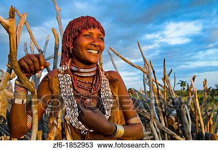 Turmi Ethiopia Africa Lower Omo Valley village with Bena Tribe First Wife smiling in sunset in wood hut village 24 View Large Photo Image Stock Image - Turmi Ethiopia Africa Lower Omo Valley village with Bena Tribe First Wife smiling in sunset in wood hut village 24. Fotosearch