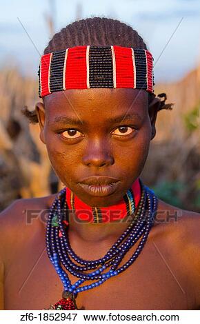 Turmi Ethiopia Africa Lower Omo Valley village with teenage Bena tribe girl portait at sunset in wood hut village 24 View Large Photo Image Stock Photo - Turmi Ethiopia Africa Lower Omo Valley village with teenage Bena tribe girl portait at sunset in wood hut village 24. Fotosearch