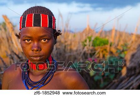 Turmi Ethiopia Africa Lower Omo Valley village with teenage Bena tribe girl portait at sunset in wood hut village 24 View Large Photo Image Stock Photo - Turmi Ethiopia Africa Lower Omo Valley village with teenage Bena tribe girl portait at sunset in wood hut village 24. Fotosearch