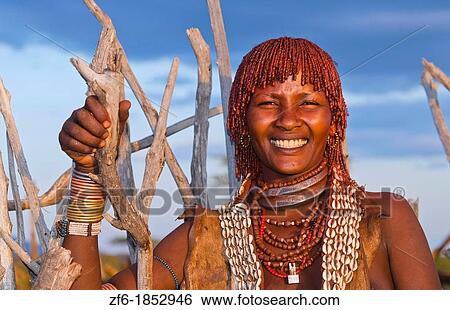Turmi Ethiopia Africa Lower Omo Valley village with Bena tribe First Wife smiling with jewelry in wild wood camp hut 24 View Large Photo Image Stock Photograph - Turmi Ethiopia Africa Lower Omo Valley village with Bena tribe First Wife smiling with jewelry in wild wood camp hut 24. Fotosearch