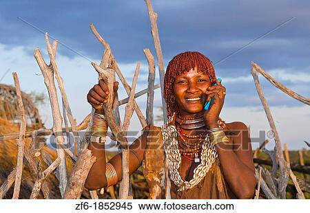 Turmi Ethiopia Africa Lower Omo Valley village with Bena tribe First Wife smiling with jewelry in wild wood camp hut 24 View Large Photo Image Stock Photography - Turmi Ethiopia Africa Lower Omo Valley village with Bena tribe First Wife smiling with jewelry in wild wood camp hut 24. Fotosearch