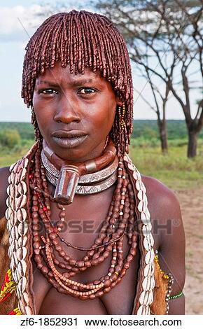 Turmi Ethiopia Africa village Lower Omo Valley Hamar Hammer tribe portrait of woman in village at sunset with First Wife necklace 24 View Large Photo Image Stock Image - Turmi Ethiopia Africa village Lower Omo Valley Hamar Hammer tribe portrait of woman in village at sunset with First Wife necklace 24. Fotosearch
