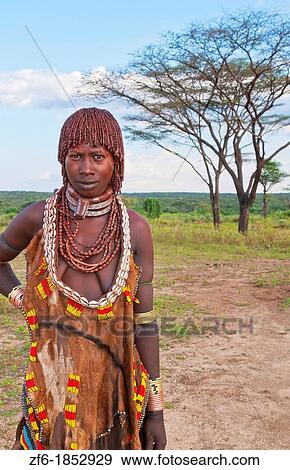 Turmi Ethiopia Africa village Lower Omo Valley Hamar Hammer tribe portrait of woman in village at sunset with First Wife necklace 24 View Large Photo Image Stock Photo - Turmi Ethiopia Africa village Lower Omo Valley Hamar Hammer tribe portrait of woman in village at sunset with First Wife necklace 24. Fotosearch
