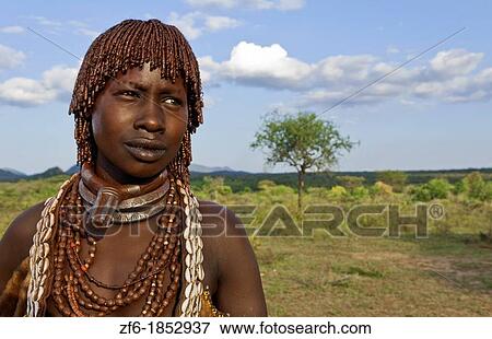 Turmi Ethiopia Africa village Lower Omo Valley Hamar Hammer tribe portrait of woman in village at sunset with First Wife necklace 24 View Large Photo Image Stock Photo - Turmi Ethiopia Africa village Lower Omo Valley Hamar Hammer tribe portrait of woman in village at sunset with First Wife necklace 24. Fotosearch
