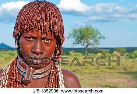 Turmi Ethiopia Africa village Lower Omo Valley Hamar Hammer tribe portrait of woman in village at sunset with First Wife necklace 24 View Large Photo Image Stock Photograph - Turmi Ethiopia Africa village Lower Omo Valley Hamar Hammer tribe portrait of woman in village at sunset with First Wife necklace 24. Fotosearch