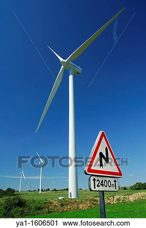 Turns ahead road sign close to a wind farm on blue sky - France View Large Photo Image Stock Image - Turns ahead road sign close to a wind farm on blue sky - France. Fotosearch