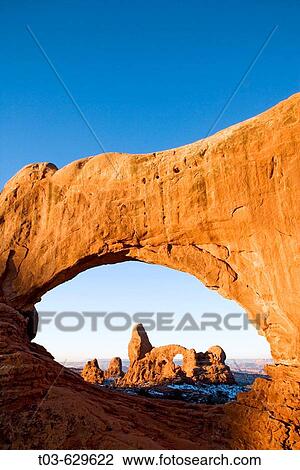 Turret Arch framed through North Window at sunrise, Arches National Park, Utah, USA. View Large Photo Image Stock Image - Turret Arch framed through North Window at sunrise, Arches National Park, Utah, USA.. Fotosearch