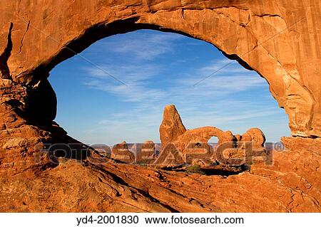 Turret Arch seen through North Window at sunrise, Arches National Park, Utah, USA. View Large Photo Image Stock Image - Turret Arch seen through North Window at sunrise, Arches National Park, Utah, USA.. Fotosearch
