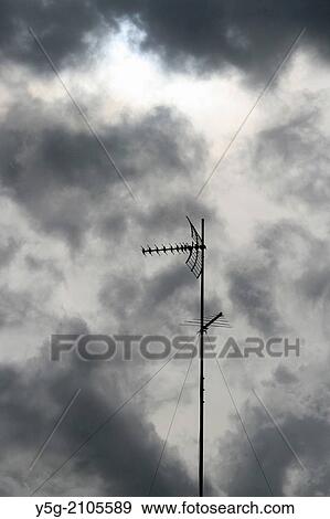 tv aerial on rooftop with dark sky View Large Photo Image Stock Photo - tv aerial on rooftop with dark sky. Fotosearch