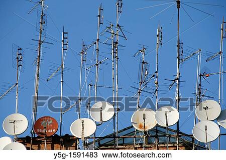 tv aerials and satellite dishes on rooftop View Large Photo Image Stock Image - tv aerials and satellite dishes on rooftop. Fotosearch