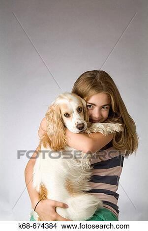 Picture - twelve year old girl with cocker spaniel. Fotosearch