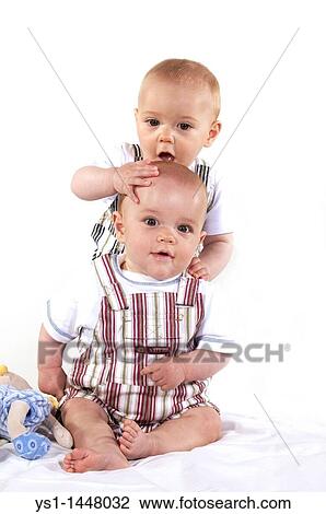 TWIN BOYS PLAYING AGAINST WHITE BACKGROUND View Large Photo Image Stock Image - TWIN BOYS PLAYING AGAINST WHITE BACKGROUND. Fotosearch