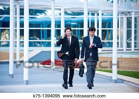 Stock Photography - Twin businessmen in a hurry. Fotosearch