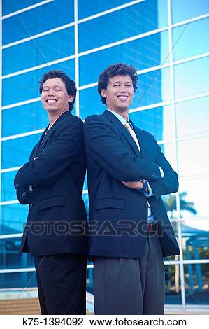Stock Image - Twin men back to back. Fotosearch