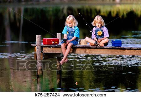 twin sisters fishing from a dock View Large Photo Image Picture - twin sisters fishing from a dock. Fotosearch