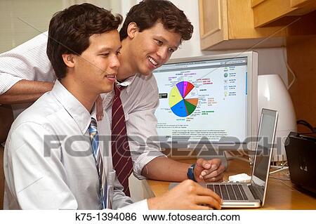 Twins at office computer View Large Photo Image Stock Photograph - Twins at office computer. Fotosearch