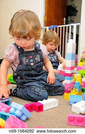 Twins playing at home View Large Photo Image Stock Image - Twins playing at home. Fotosearch