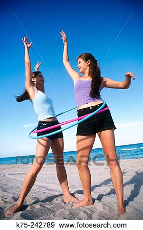 Stock Photo - Twins playing on a beach. Fotosearch