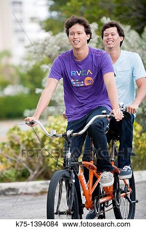 Twins riding tandem bike View Large Photo Image Picture - Twins riding tandem bike. Fotosearch