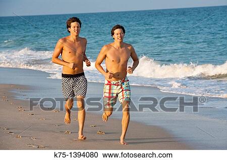 Twins running on the beach View Large Photo Image Stock Image - Twins running on the beach. Fotosearch