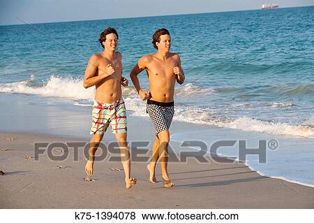 twins running on the beach View Large Photo Image Stock Photo - twins running on the beach. Fotosearch