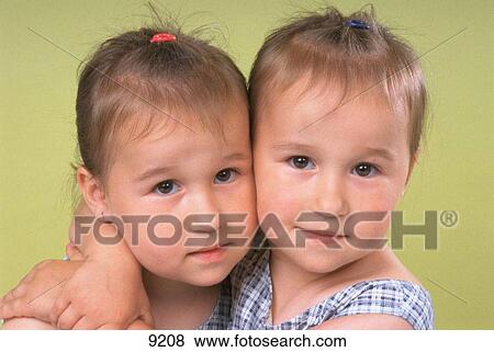 Stock Photo - Twins sisters. Fotosearch