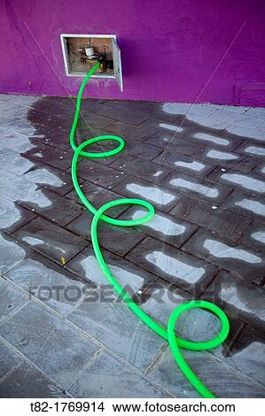 twisted water hose out making green urban irrigation. View Large Photo Image Picture - twisted water hose out making green urban irrigation.. Fotosearch