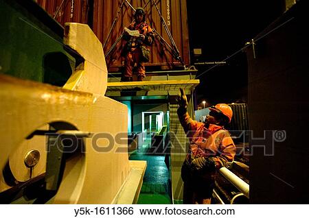 Two? Able Seamen? or sailors are receiving and placing new containers on the deck of container-vessel MV Flintercape, who sails from Rotterdam, Netherlands to Sundsvall, Sweden. The men are both Indonesian men. View Large Photo Image Stock Photograph - Two? Able Seamen? or sailors are receiving and placing new containers on the deck of container-vessel MV Flintercape, who sails from Rotterdam, Netherlands to Sundsvall, Sweden. The men are both Indonesian men.. Fotosearch