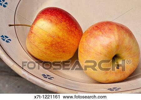 Stock Image - two apples in a bowl. Fotosearch