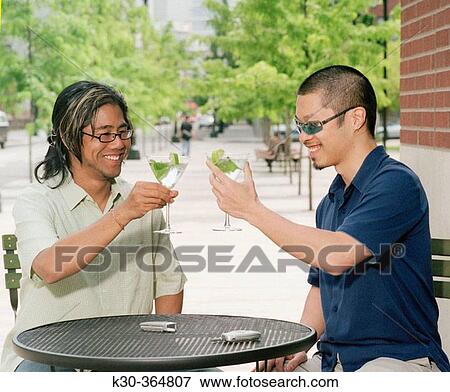 Two Asian men toasting martini's in outdoor resturant. View Large Photo Image Stock Photo - Two Asian men toasting martini's in outdoor resturant.. Fotosearch