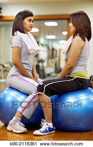 Two asian women doing excercises on a gymnastic ball and looking at eachotherr, Jakarta, Indonesia, Southeast Asia. View Large Photo Image Stock Image - Two asian women doing excercises on a gymnastic ball and looking at eachotherr, Jakarta, Indonesia, Southeast Asia.. Fotosearch