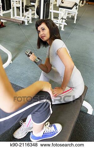 Stock Photo - Two asian women doing weightlifting with dumbbells, Jakarta, Indonesia, Southeast Asia.. Fotosearch