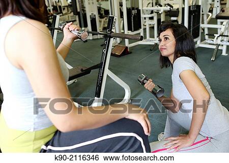 Two asian women holding a small dumbbell, Jakarta, Indonesia, Southeast Asia. View Large Photo Image Stock Photograph - Two asian women holding a small dumbbell, Jakarta, Indonesia, Southeast Asia.. Fotosearch