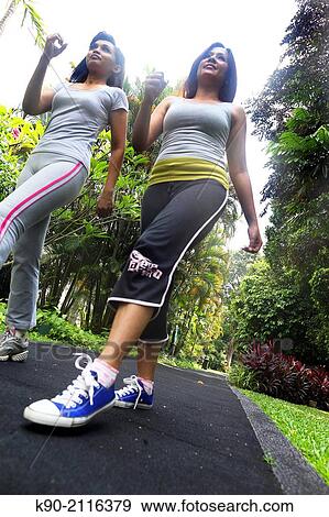 Two asian women jogging in the garden, Jakarta, Indonesia, Southeast Asia. View Large Photo Image Stock Photo - Two asian women jogging in the garden, Jakarta, Indonesia, Southeast Asia.. Fotosearch