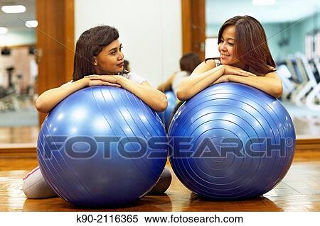 Two asian women relaxiing on a gymnastic ball, Jakarta, Indonesia, Southeast Asia. View Large Photo Image Stock Photography - Two asian women relaxiing on a gymnastic ball, Jakarta, Indonesia, Southeast Asia.. Fotosearch