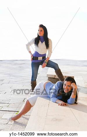 Two attractive young women posing outdoors View Large Photo Image Stock Photo - Two attractive young women posing outdoors. Fotosearch