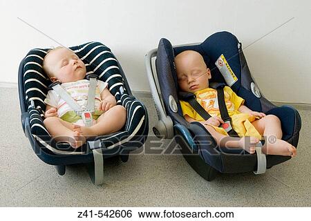 Two babies sleeping in a maxicosy. View Large Photo Image Stock Photograph - Two babies sleeping in a maxicosy.. Fotosearch