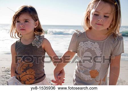 Two baby girls at the beach View Large Photo Image Stock Photograph - Two baby girls at the beach. Fotosearch