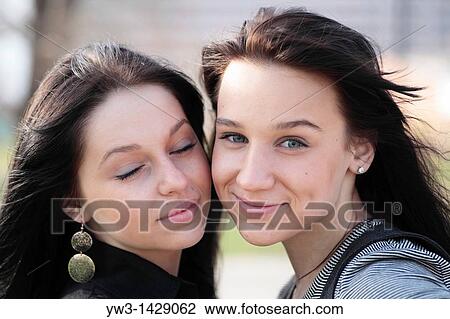 Stock Image - two beautiful brunette outdoor portrait. Fotosearch