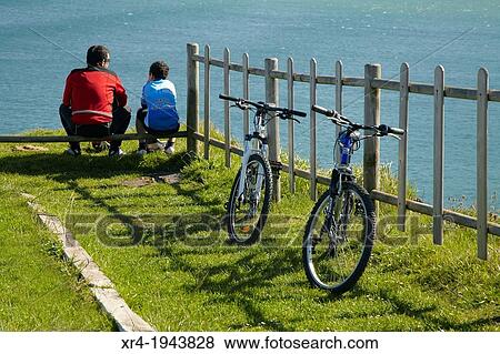 Stock Photo - Two bikers in Cargadero of Covar? n, Muskiz, Biscay. Fotosearch