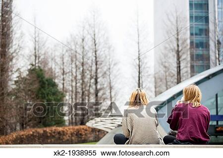 Two blond girls seated viewed from back View Large Photo Image Stock Photography - Two blond girls seated viewed from back. Fotosearch