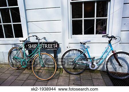 Picture - Two Blue stroll dutch bikes parked in front of a street sign, Oxford, UK. Fotosearch