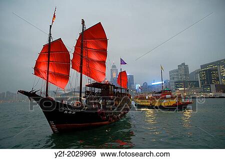Two boats pass each other at night on Victoria Harbour, Hong Kong - the iconic Aqua Luna with Red Sails and a Wing On Travel boat View Large Photo Image Stock Photo - Two boats pass each other at night on Victoria Harbour, Hong Kong - the iconic Aqua Luna with Red Sails and a Wing On Travel boat. Fotosearch