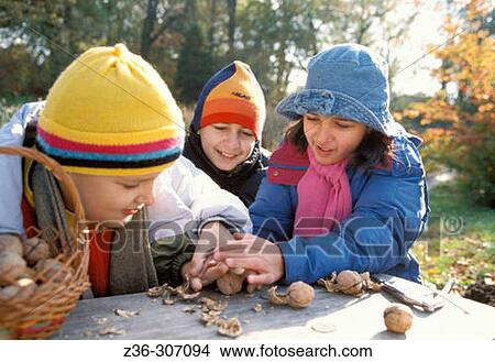 Two boy and one girl with nuts View Large Photo Image Picture - Two boy and one girl with nuts. Fotosearch