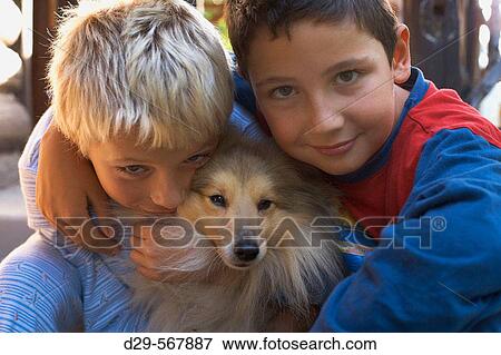 Two boys and a dog View Large Photo Image Stock Photo - Two boys and a dog. Fotosearch