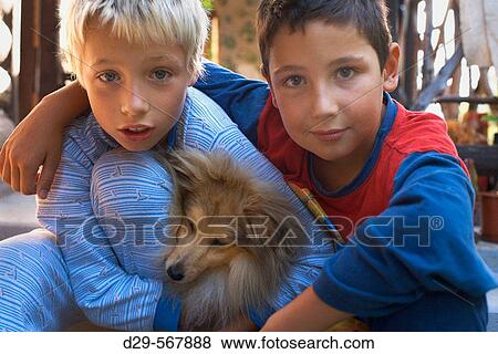 Two boys and a dog View Large Photo Image Stock Photo - Two boys and a dog. Fotosearch
