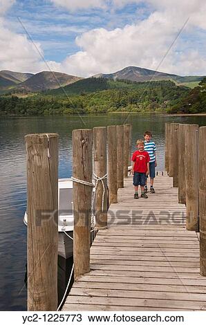 Two boys at Derwent water at Keswick, Lake District National Park, Cumbria, England, Great Britain, Uk View Large Photo Image Stock Image - Two boys at Derwent water at Keswick, Lake District National Park, Cumbria, England, Great Britain, Uk. Fotosearch