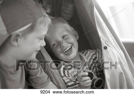 Two boys having fun in their inside of camping car View Large Photo Image Picture - Two boys having fun in their inside of camping car. Fotosearch