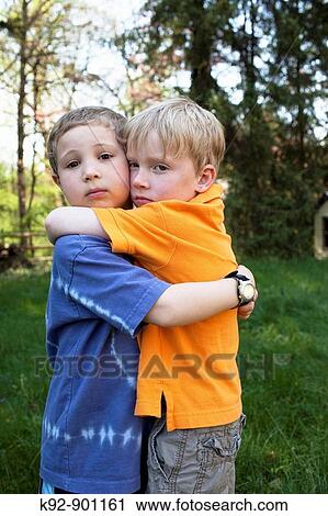 Two boys hugging View Large Photo Image Stock Image - Two boys hugging. Fotosearch